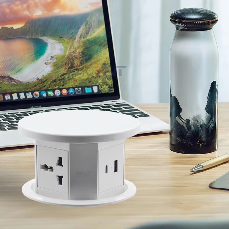 PP110M3 pop up socket raised on a worktop next to a laptop